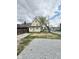 Two-story home with yellow siding and a large yard with a detached gravel parking space at 3502 N Illinois St, Indianapolis, IN 46208