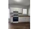 Well-lit kitchen features white cabinets, dark countertops, and modern appliances at 3502 N Illinois St, Indianapolis, IN 46208