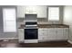 Well-lit kitchen features white cabinets, dark countertops, and modern appliances at 3502 N Illinois St, Indianapolis, IN 46208