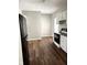 Kitchen featuring hardwood floors, white cabinets, and modern black and white appliances at 3502 N Illinois St, Indianapolis, IN 46208
