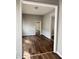 Bright living room with hardwood floors, neutral paint and trim, and an open doorway leading to other rooms at 3502 N Illinois St, Indianapolis, IN 46208