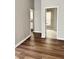Hardwood floors connecting multiple rooms, including a glimpse of a kitchen with white cabinets and tile flooring at 3502 N Illinois St, Indianapolis, IN 46208