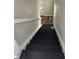 Staircase with black painted stairs and white trim leading to the upper floor at 3502 N Illinois St, Indianapolis, IN 46208