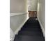 Staircase with black painted stairs and white trim leading to the upper floor at 3502 N Illinois St, Indianapolis, IN 46208