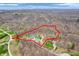 An aerial view shows the expansive property surrounded by lush forest, marked by a red outline at 3504 Morgan Oaks Cir, Martinsville, IN 46151
