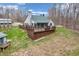 Aerial view of the home showcasing the spacious yard, back deck, and surrounding lush greenery at 3504 Morgan Oaks Cir, Martinsville, IN 46151