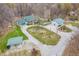 Aerial view displays a house with well-maintained grounds, outbuildings, and a circular gravel driveway at 3504 Morgan Oaks Cir, Martinsville, IN 46151