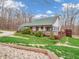 Charming home with green roof, inviting porch, and well-maintained landscaping for curb appeal at 3504 Morgan Oaks Cir, Martinsville, IN 46151