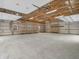 Spacious garage interior with concrete floors, unfinished walls, high ceilings, and wooden shelves at 3504 Morgan Oaks Cir, Martinsville, IN 46151