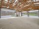 Open garage with unfinished walls, high ceilings, a concrete floor, and an open garage door at 3504 Morgan Oaks Cir, Martinsville, IN 46151