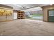 Open garage showcasing a view of the outdoors, shelving, and a refrigerator for added convenience at 3504 Morgan Oaks Cir, Martinsville, IN 46151