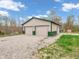 Large detached garage with multiple bays and gravel driveway offers plenty of parking and storage at 3504 Morgan Oaks Cir, Martinsville, IN 46151