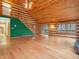 Spacious living room features hardwood floors, log walls, high ceilings, and large windows offering ample natural light at 3504 Morgan Oaks Cir, Martinsville, IN 46151