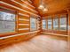 Inviting living room filled with natural light, wood-paneled walls, and hardwood floors, perfect for relaxation at 3504 Morgan Oaks Cir, Martinsville, IN 46151