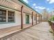 Long front porch featuring wooden flooring, teal trim, wood columns, and outdoor lighting at 3504 Morgan Oaks Cir, Martinsville, IN 46151