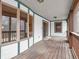 Covered porch with wood flooring and white railings, offering a peaceful outdoor space at 3504 Morgan Oaks Cir, Martinsville, IN 46151