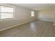 Spacious basement with laminate flooring, three windows, and neutral paint, offering a versatile living space at 3550 Winings Ave, Indianapolis, IN 46221