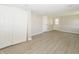 Basement features laminate flooring, an exterior door with sidelights, closet with sliding doors, and neutral paint at 3550 Winings Ave, Indianapolis, IN 46221