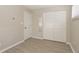 Bright bedroom featuring light wood floors, closet with white sliding doors and an entry door at 3550 Winings Ave, Indianapolis, IN 46221