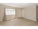 Bright living room features modern flooring, neutral walls, and a large window with natural light at 3550 Winings Ave, Indianapolis, IN 46221