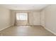 Bright living room features modern flooring, neutral walls, and a large window with natural light at 3550 Winings Ave, Indianapolis, IN 46221