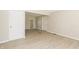 Spacious room with modern flooring, neutral paint and multiple entryways to other parts of the home at 3550 Winings Ave, Indianapolis, IN 46221