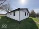 Backyard view of a white brick home next to a pond at 3689 S County Road 800 W, Coatesville, IN 46121