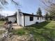 Side view of the home, patio, and a grassy backyard at 3689 S County Road 800 W, Coatesville, IN 46121