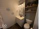 Tastefully designed bathroom featuring shiplap walls, modern vanity, decorative shelving and updated fixtures at 3689 S County Road 800 W, Coatesville, IN 46121