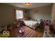 Cozy bedroom with a playful dinosaur themed wall featuring natural light and hardwood floors at 3689 S County Road 800 W, Coatesville, IN 46121