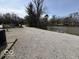 Gravel driveway leading to a lake with parked vehicles and boats at 3689 S County Road 800 W, Coatesville, IN 46121
