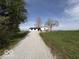 Scenic shot of a home with a gravel driveway and a yard at 3689 S County Road 800 W, Coatesville, IN 46121