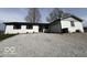 Single-story home with white brick, black shutters, and a gravel driveway at 3689 S County Road 800 W, Coatesville, IN 46121