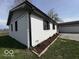Side view of a white brick home with landscaped flower beds at 3689 S County Road 800 W, Coatesville, IN 46121