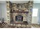 Stone fireplace with a hearth, mantel, and a wood-burning stove at 3689 S County Road 800 W, Coatesville, IN 46121