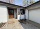 Home's entrance features a wooden front door, a 'welcome' sign, and an attached garage at 3689 S County Road 800 W, Coatesville, IN 46121