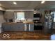 Updated kitchen featuring gray cabinets, stainless steel appliances, and butcher block countertops at 3689 S County Road 800 W, Coatesville, IN 46121