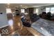 Open-concept living area with hardwood floors, stone fireplace, and stainless steel appliances at 3689 S County Road 800 W, Coatesville, IN 46121
