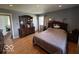 Large bedroom with hardwood floors, a dresser, and an ensuite bathroom at 3689 S County Road 800 W, Coatesville, IN 46121