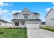 Charming two-story home with a two-car garage and a well-manicured lawn at 3787 Thomas Jefferson St, Westfield, IN 46074