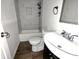 Updated bathroom featuring a shower with gray tiling and a white vanity sink at 408 E Beecher St, Indianapolis, IN 46225