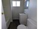 Cozy bathroom featuring a toilet, sink, mirror and shower at 408 E Beecher St, Indianapolis, IN 46225