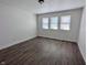 Bright bedroom featuring three windows, white walls, and modern wood-look flooring at 408 E Beecher St, Indianapolis, IN 46225