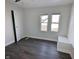 Bright bedroom featuring two windows, wood-look floors, and a closet at 408 E Beecher St, Indianapolis, IN 46225