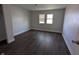 Bedroom with hardwood floors, two windows, and neutral paint at 408 E Beecher St, Indianapolis, IN 46225