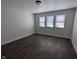 This bedroom features three windows and hardwood floors at 408 E Beecher St, Indianapolis, IN 46225
