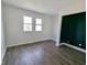 Bedroom with stylish wood-look floors, bright white walls, and natural light from windows at 408 E Beecher St, Indianapolis, IN 46225