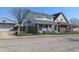Two-story duplex featuring a well-maintained front yard and an open porch at 408 E Beecher St, Indianapolis, IN 46225