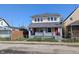 Charming two-story duplex with a fenced yard and inviting front porch at 408 E Beecher St, Indianapolis, IN 46225
