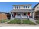 Inviting two-story home with red doors and a chain link fence surrounding the front yard at 408 E Beecher St, Indianapolis, IN 46225